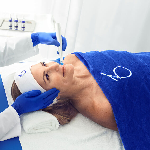 Woman receiving facial treatment